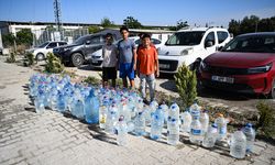 Hatay'daki orman yangınına müdahaleye, konteyner kentteki çocuklardan pet şişeli destek